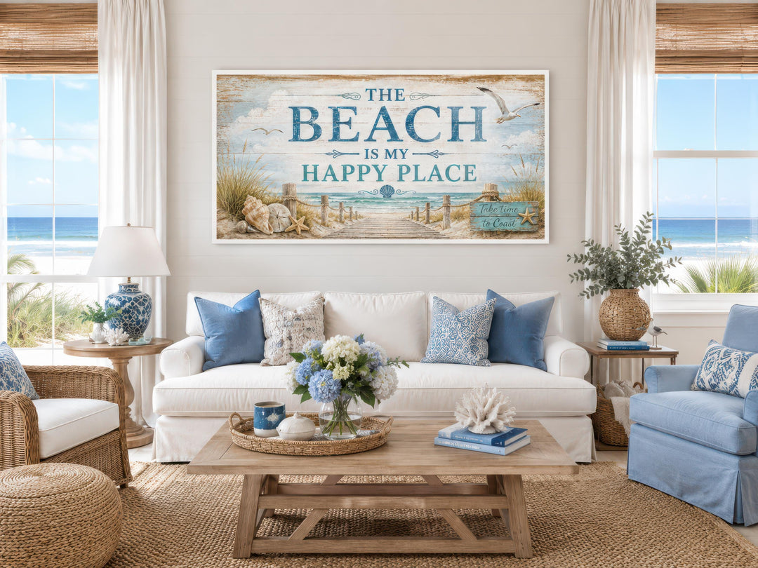 The Beach Is My Happy Place coastal wall art above a white sofa in a bright beach house living room.