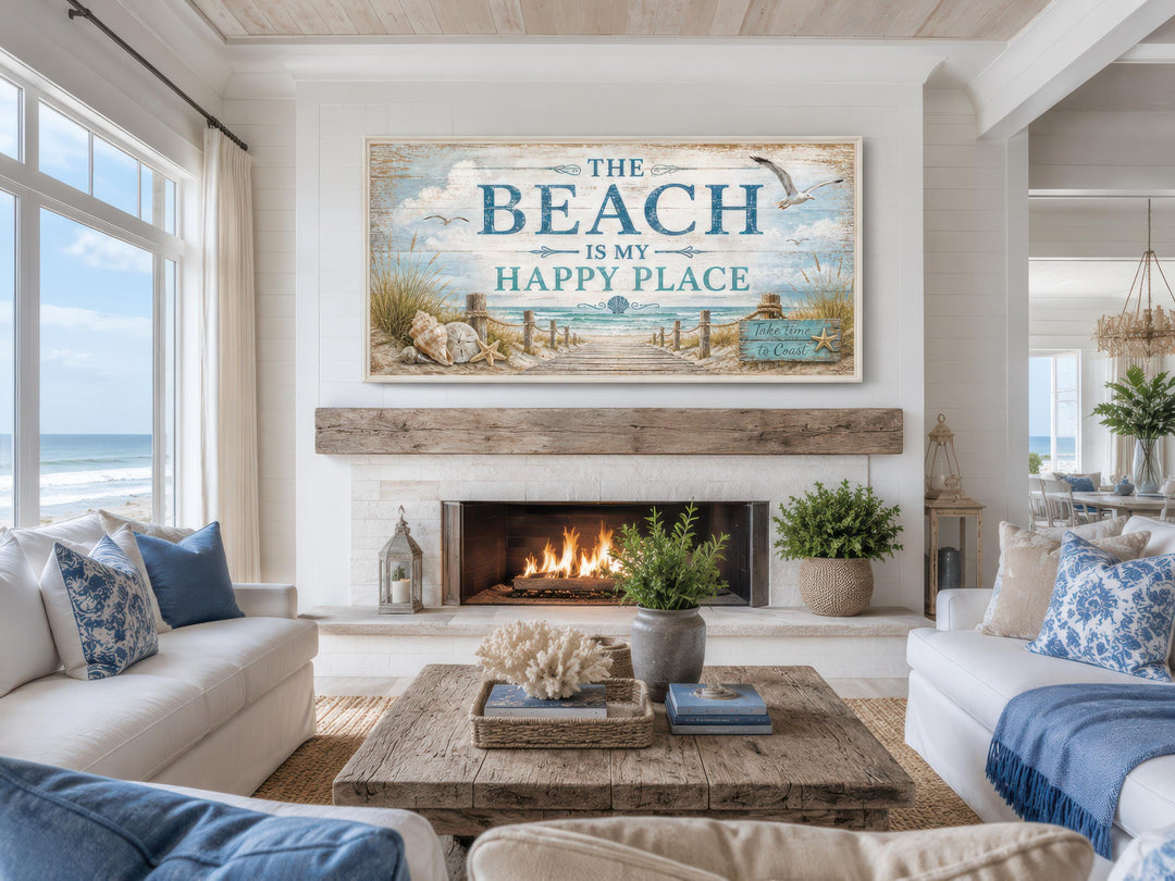 The Beach Is My Happy Place Sign canvas wall art hanging above a fireplace in a coastal living room.