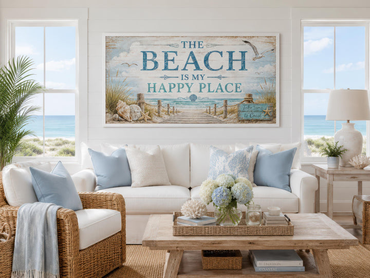 Coastal living room with a large wall art sign reading "The Beach Is My Happy Place" above a sofa.
