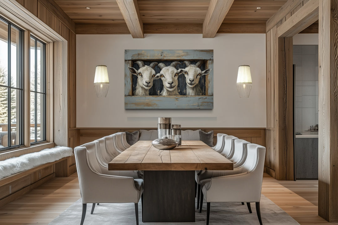 Three funny goats looking through a fake wooden window canvas wall art in a rustic dining room.
