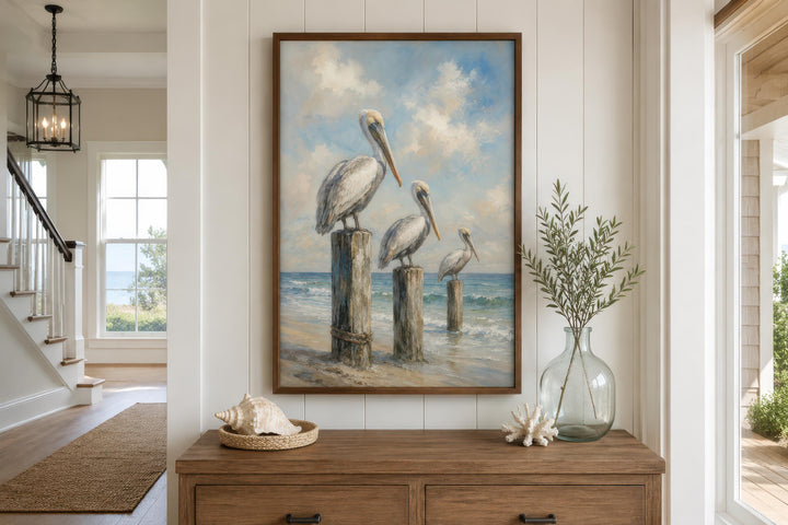 Three pelicans perched on weathered dock posts in a coastal canvas wall art painting.