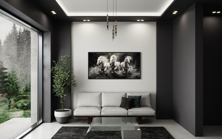 Three White Horses Running Framed Canvas Wall Art above a modern sofa in a minimalist living room.