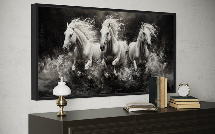 Three White Horses Running Framed Canvas Wall Art displayed above a dark wooden dresser.