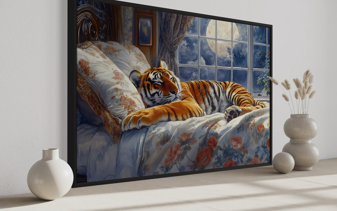 Framed canvas wall art of a tiger sleeping in a bed by a moonlit window in a bedroom setting.