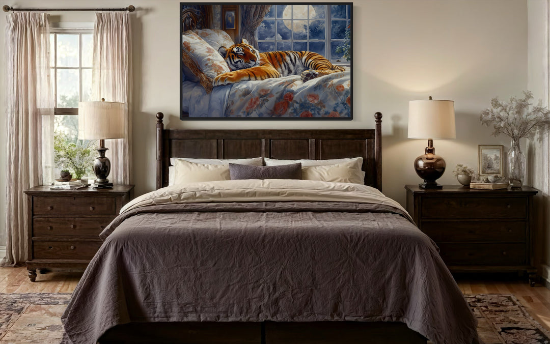 Framed canvas wall art of a tiger sleeping in a bed by a moonlit window above a dark wood bed frame.