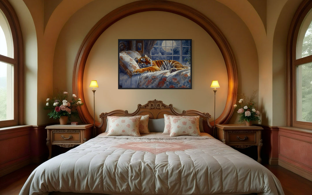 Framed canvas wall art of a tiger sleeping in a bed by a moonlit window, hung above a bedroom bed.