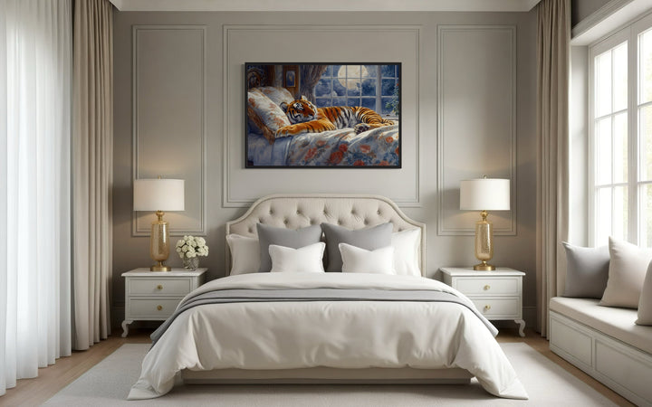 Framed canvas wall art of a tiger sleeping in a bed by a moonlit window above a bedroom headboard.