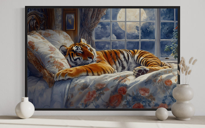Framed canvas wall art of a tiger sleeping on a floral bed by a moonlit window.