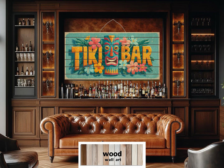 A colorful Tiki Bar sign on distressed wood planks hangs above a home bar with a leather sofa.