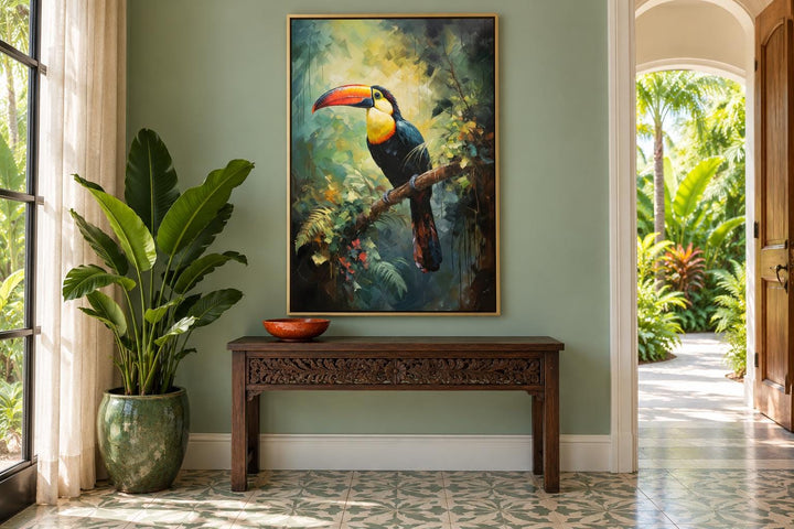Toucan in the Rainforest tropical framed canvas wall art hanging above a dark wood console table.
