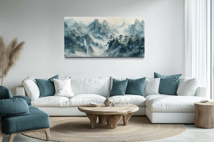 Traditional Chinese mountain landscape Shan Shui Hua style framed canvas art above a white sofa.