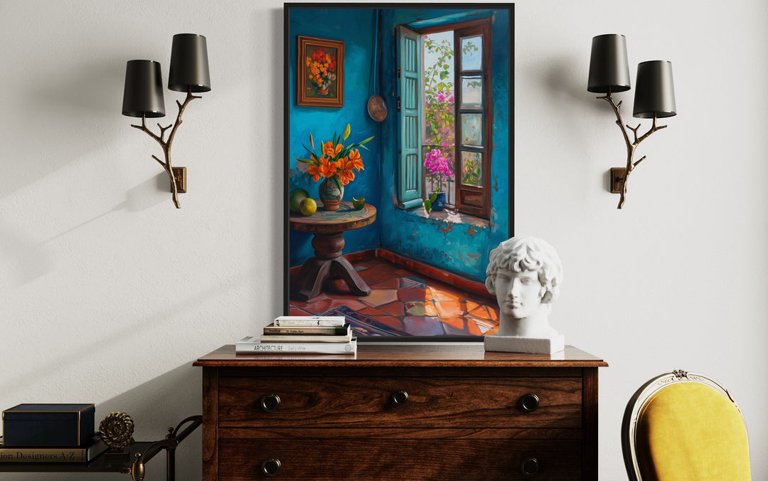 Traditional Mexico room wall art above a wooden dresser with a bust and branch-style wall sconces.