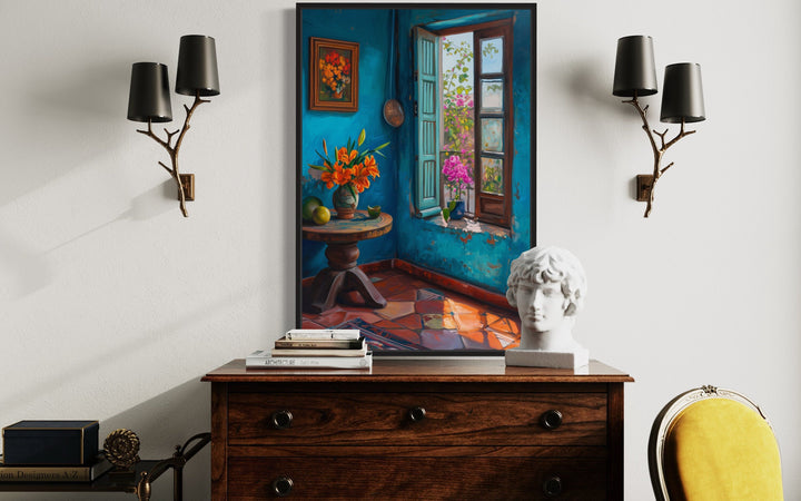 Traditional Mexico room wall art above a wooden dresser with a bust and branch-style wall sconces.