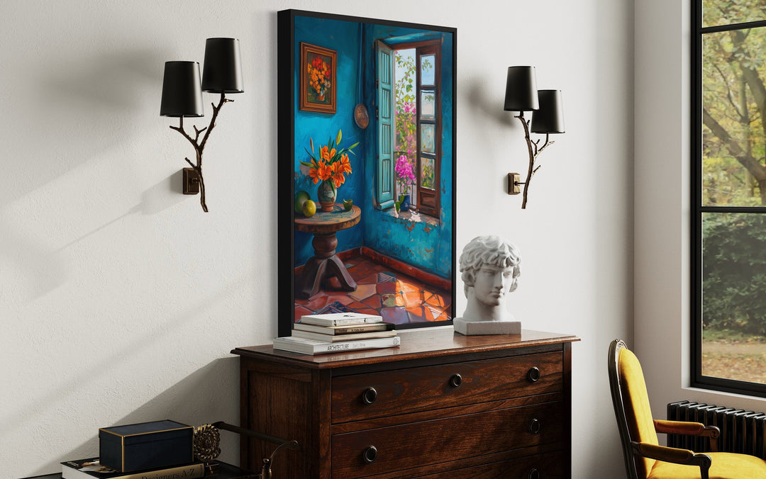 Traditional Mexico room wall art with a blue interior, window, and flowers on a wooden dresser.