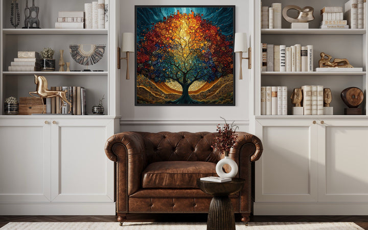 Tree of Life stained glass style Yggdrasil square framed canvas wall art above a leather armchair.