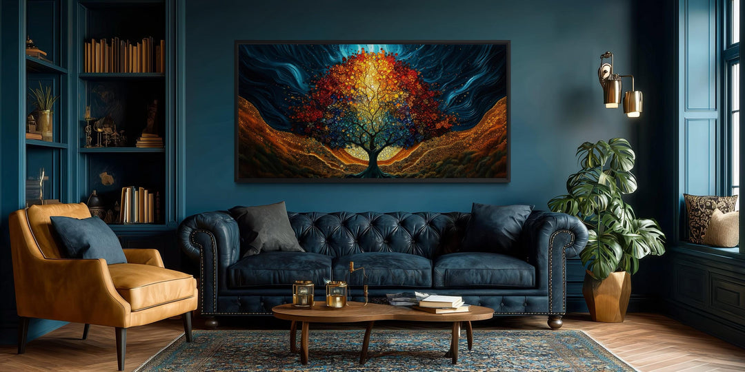 A colorful canvas print of a glowing tree of life hangs above a navy sofa in a modern living room.