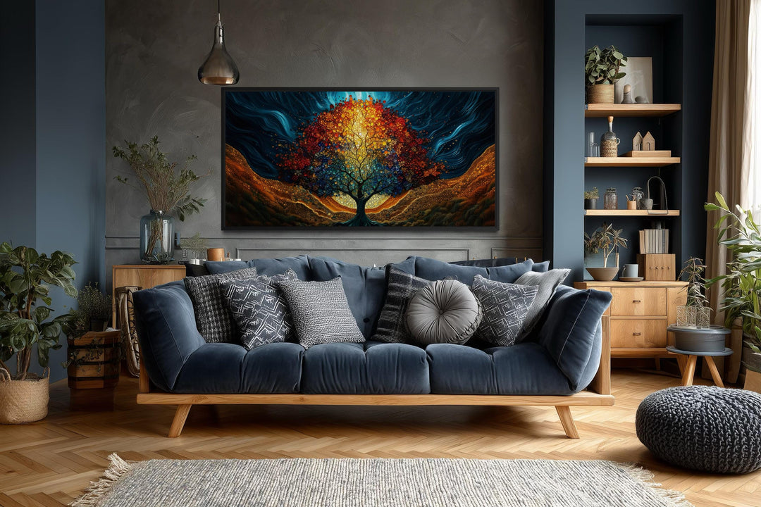 A colorful canvas print of a glowing Tree of Life hangs above a blue sofa in a modern living room.