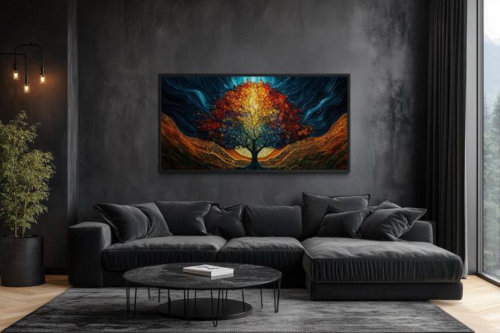 A colorful canvas print of a glowing Tree of Life hangs in a modern, dark-toned living room.
