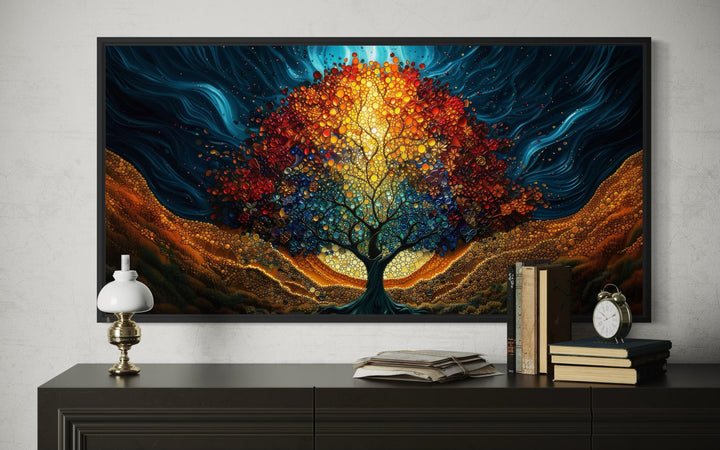 A colorful canvas print of a glowing Tree of Life displayed on a wall above a dark wooden dresser.
