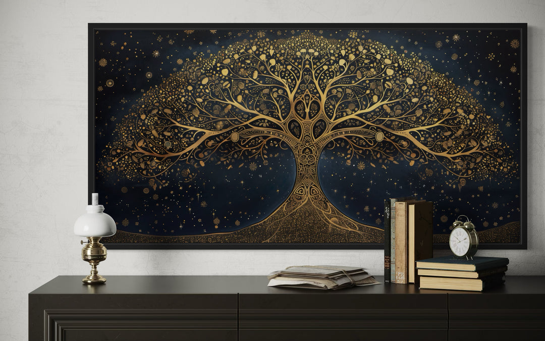 Framed canvas wall art of a golden Tree of Life on a navy blue background above a dark dresser.