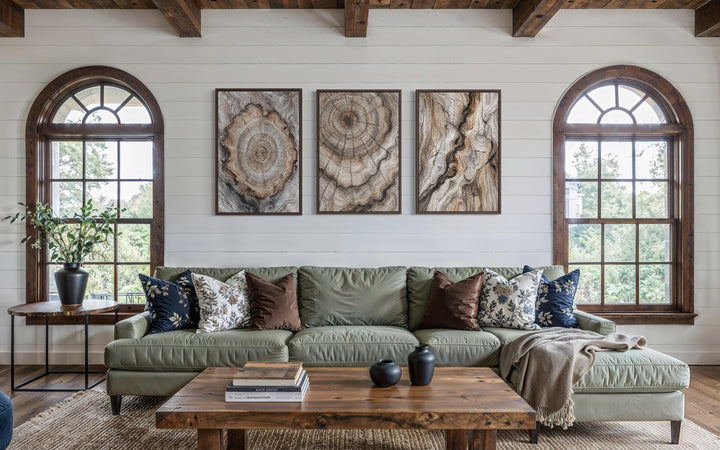 Tree Rings Wood Grain Set of 3 Canvas Wall Art displayed as a triptych above a green sofa.