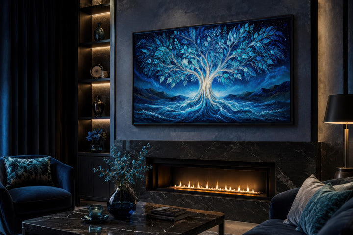 Mystical blue Tree of Life canvas wall art displayed above a modern fireplace in a dark living room.