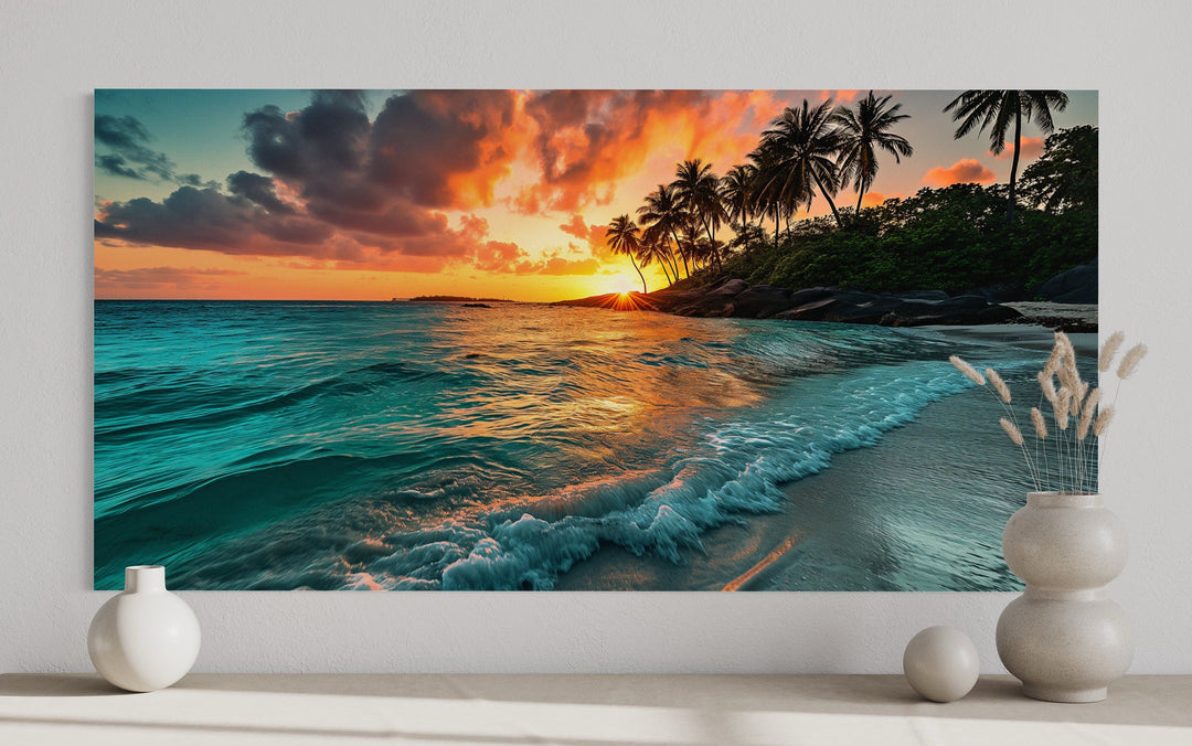 Framed canvas wall art of a tropical beach sunset with palm trees and turquoise ocean waves.