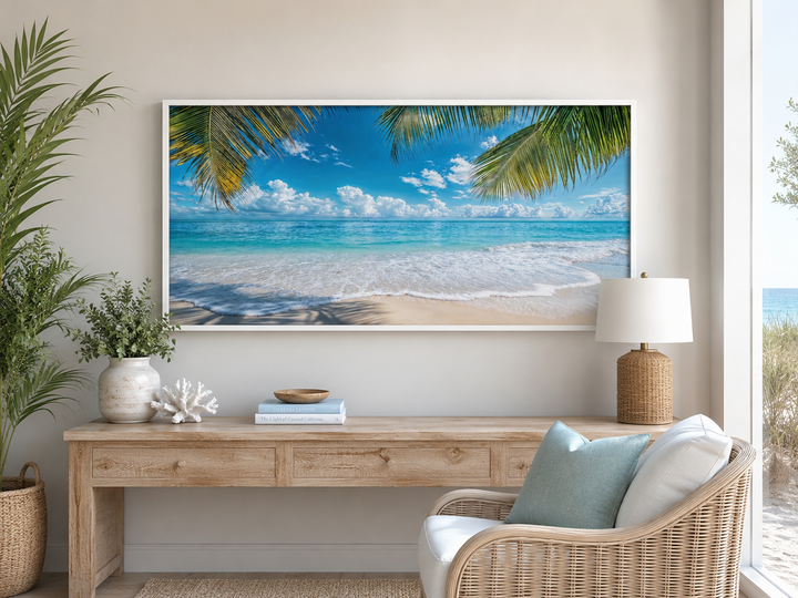 Tropical beach with palm trees framed canvas wall art hanging above a wooden console table.
