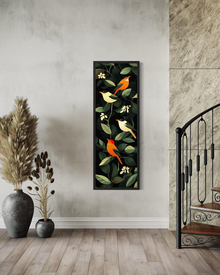 Vertical narrow canvas wall art featuring colorful tropical birds and leaves in a black frame.