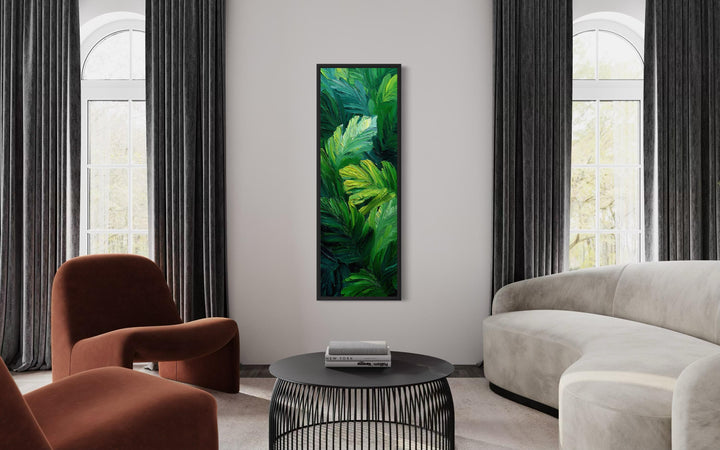 Vertical canvas print of lush tropical leaves in vibrant green tones hanging in a modern living room.