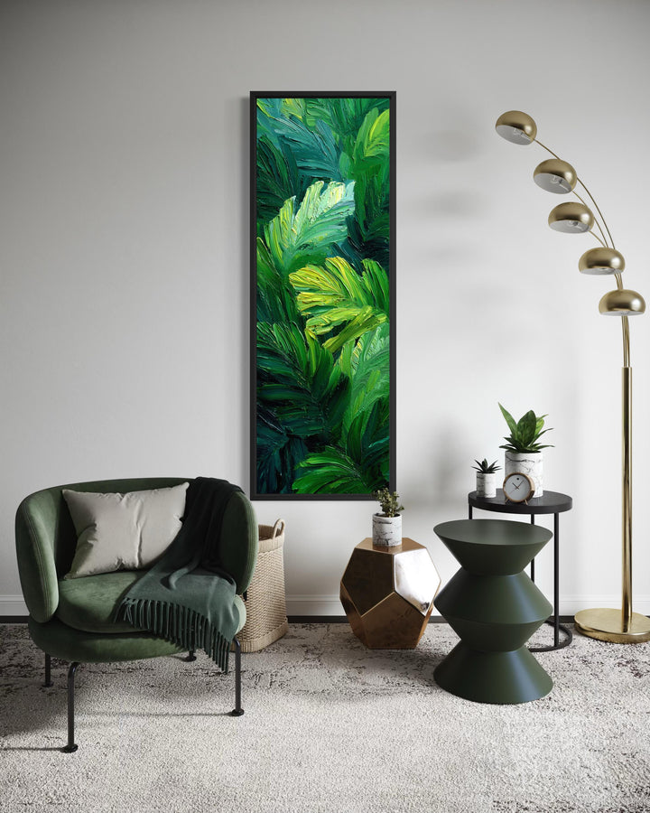 Vertical canvas print of a lush tropical jungle painting with vibrant green leaves on a white wall.