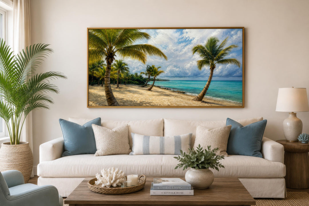 Tropical palm tree wall art canvas print hanging above a white sofa in a coastal living room.
