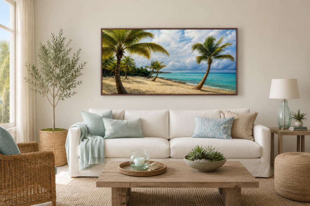 Tropical palm tree wall art canvas print hanging above a white sofa in a coastal living room.
