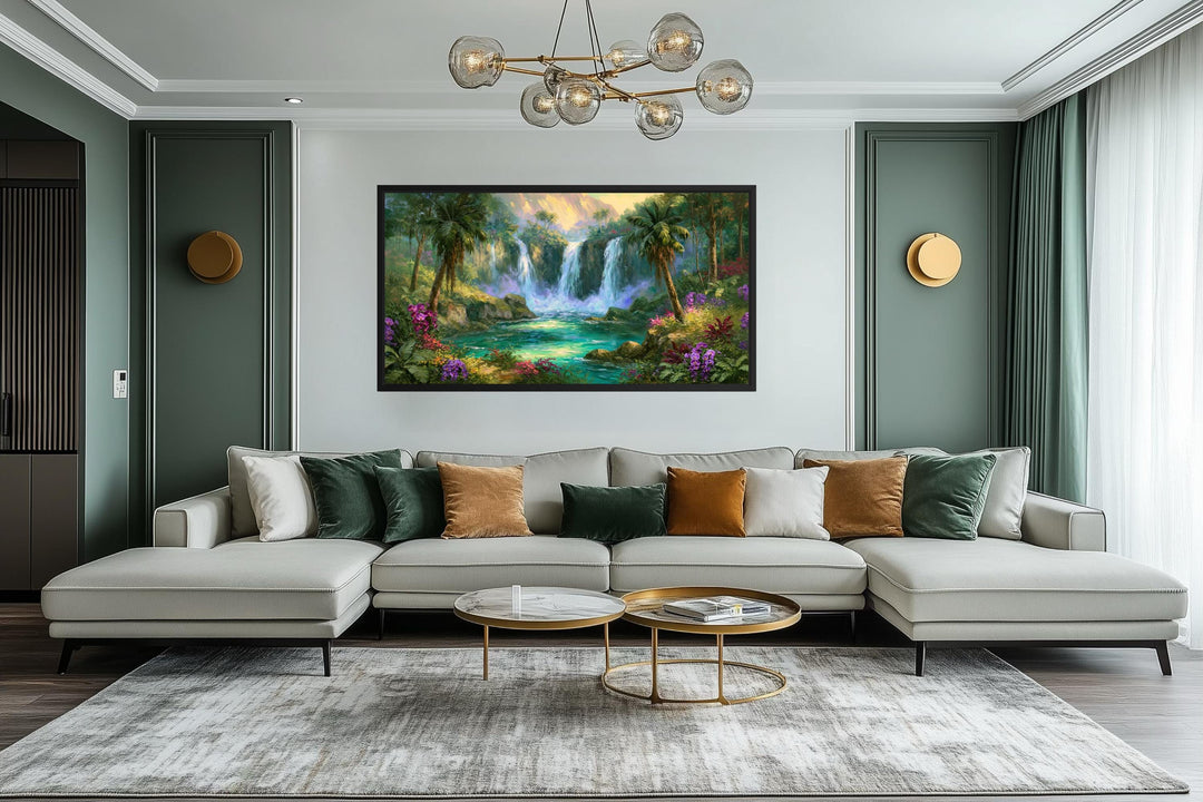 A wide horizontal canvas print of a lush tropical waterfall hangs above a modern sectional sofa.