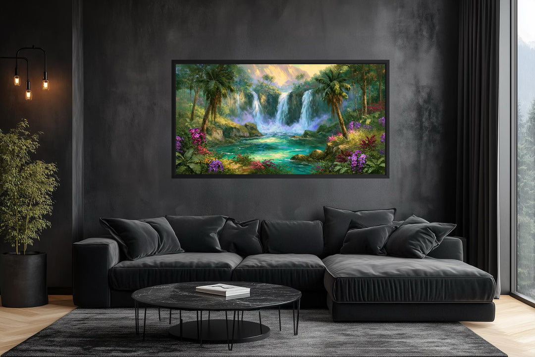 A wide horizontal canvas of a lush tropical waterfall hangs above a modern black sectional sofa.