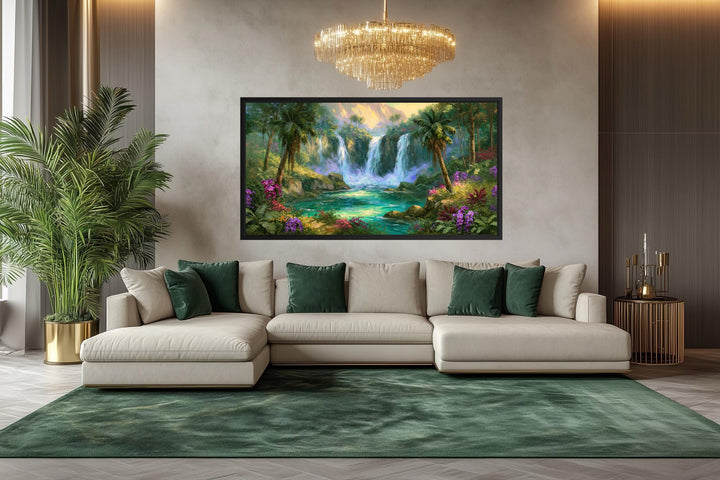 A wide horizontal canvas print of a lush tropical waterfall scene hangs in a modern living room.