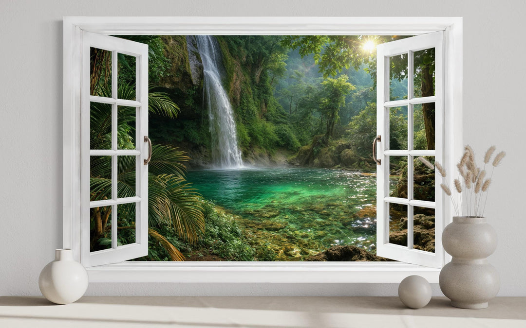 A white window frame canvas art showing a tropical waterfall cascading into a green lagoon.