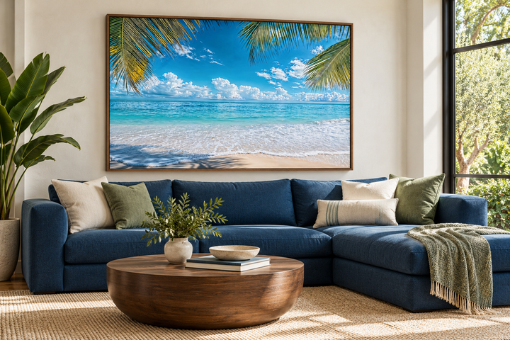 Tropical Beach With Palm Tree Framed Canvas Wall Art above a blue sectional sofa.