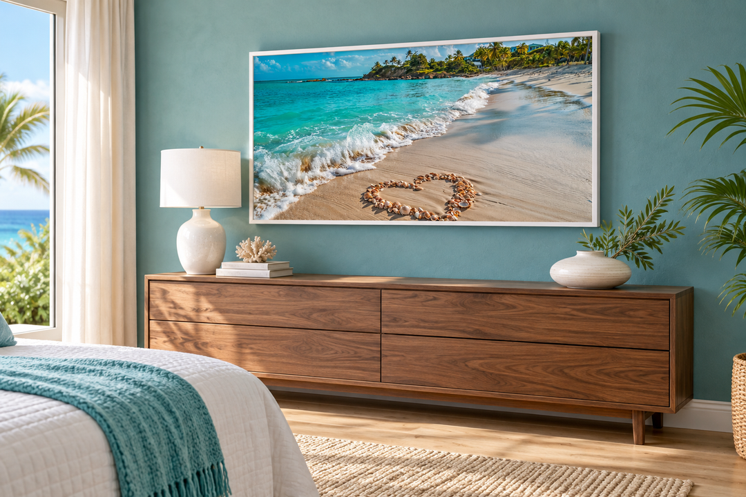 Tropical beach framed canvas wall art with heart-shaped seashells on a sandy shore above a dresser.