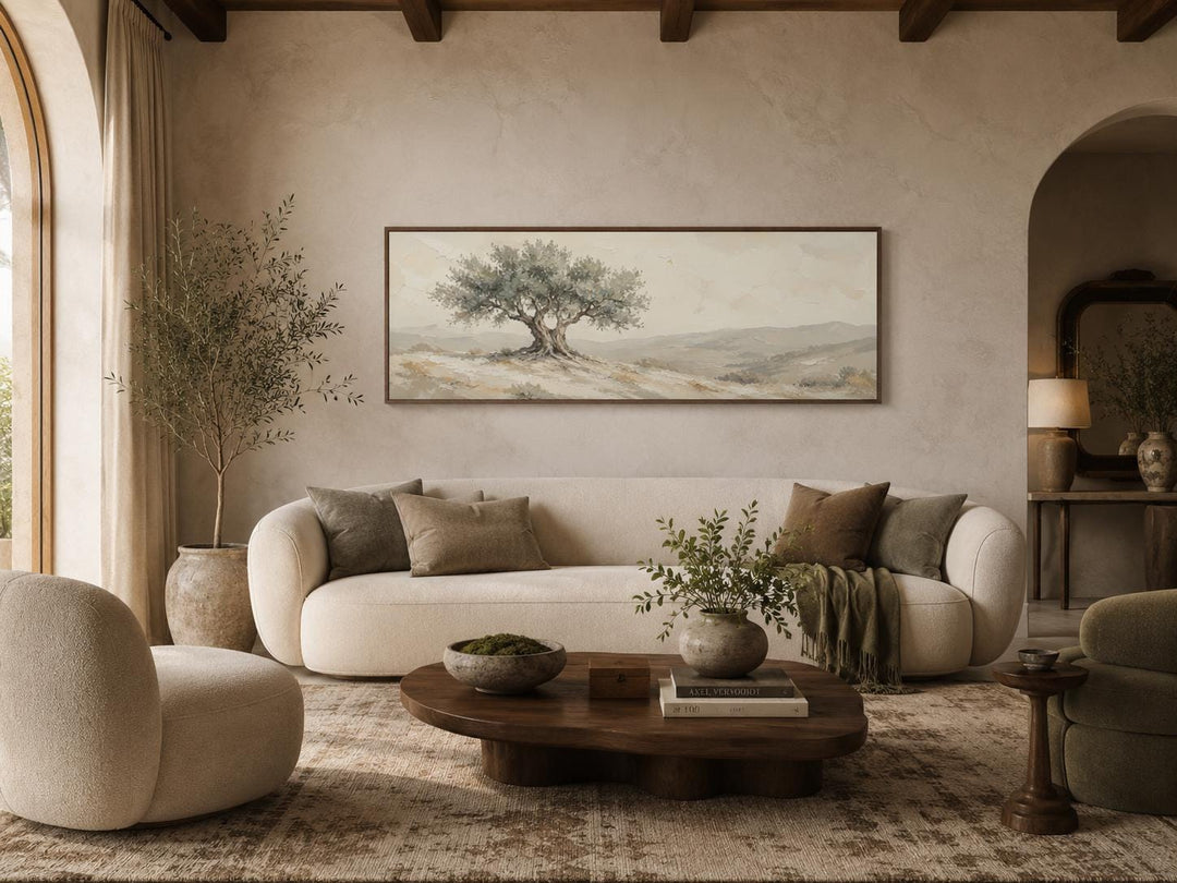 Long horizontal canvas print of a Tuscan olive tree in sage green and neutral tones above a sofa.