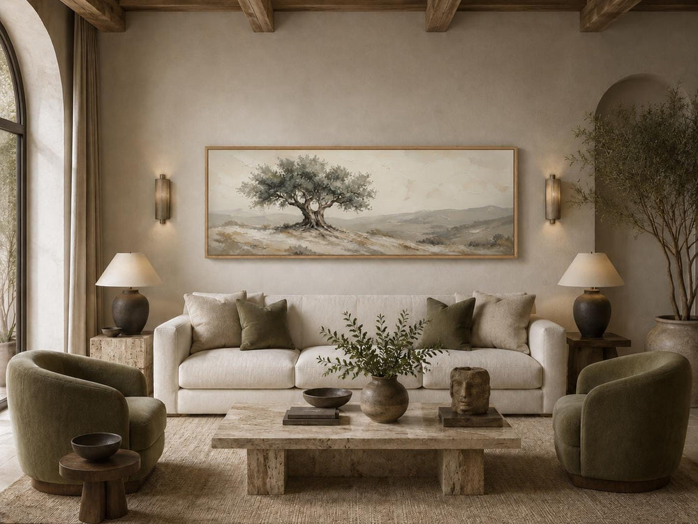 Tuscan olive tree canvas print in sage green and neutral tones above a cream sofa in a living room.