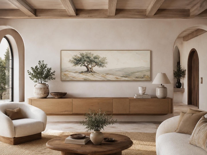 Long horizontal canvas print of a Tuscan olive tree in sage green and neutral tones above a console.