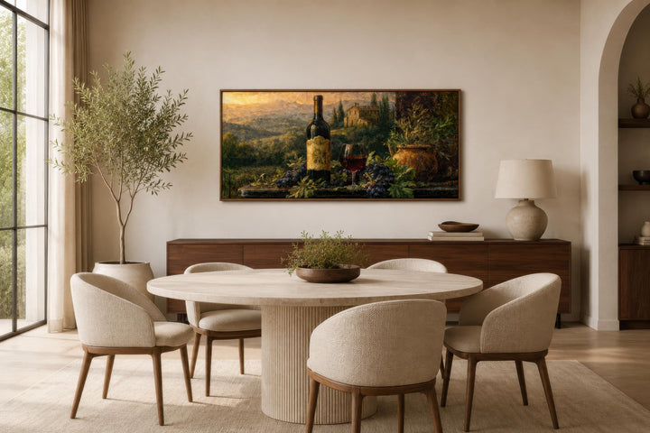 Tuscan wine bottle painting on canvas displayed in a modern dining room with a round stone table.