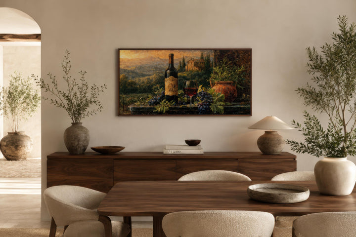 Tuscan wine bottle and vineyard landscape painting displayed in a modern dining room.
