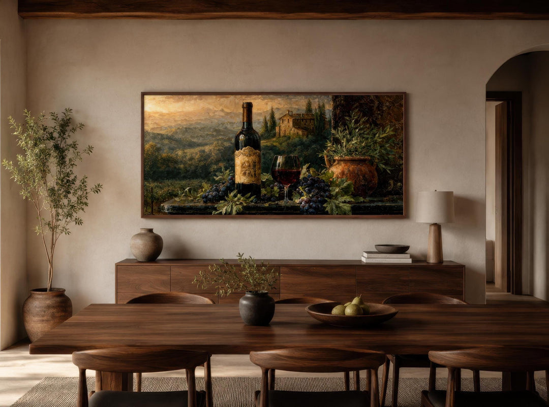 A horizontal canvas painting of a Tuscan wine still life hangs in a modern, minimalist dining room.