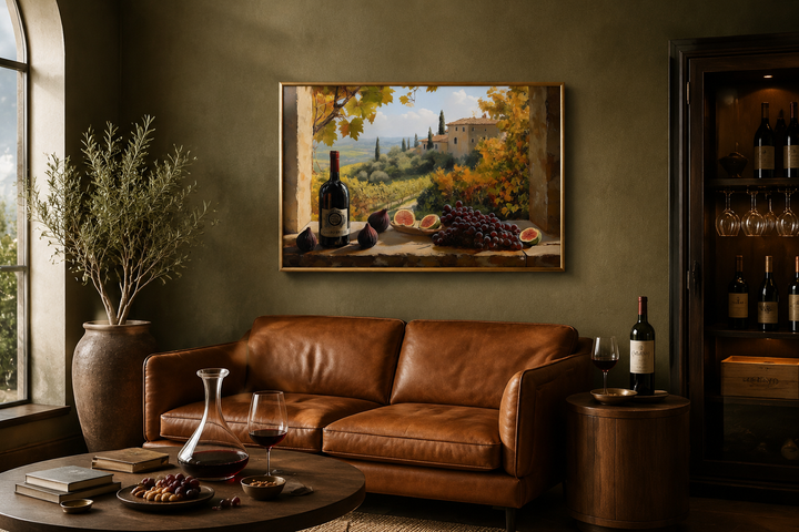 Tuscany vineyard window view wall art with wine bottle and grapes above a brown leather sofa.