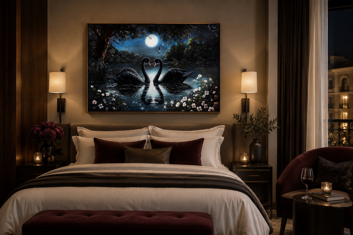 Framed canvas art of two black swans on a moonlit lake hanging above a bed in a bedroom.