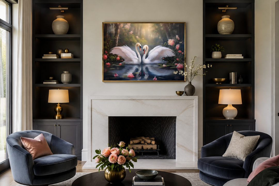 Framed canvas wall art of two white swans on a lake, hung above a marble fireplace in a living room.