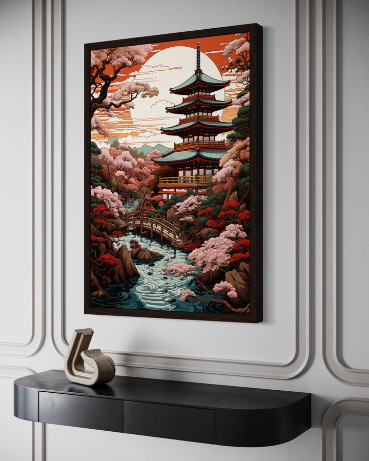 Ukiyo-e style framed canvas art of a Japanese pagoda, garden, and bridge over a stream.