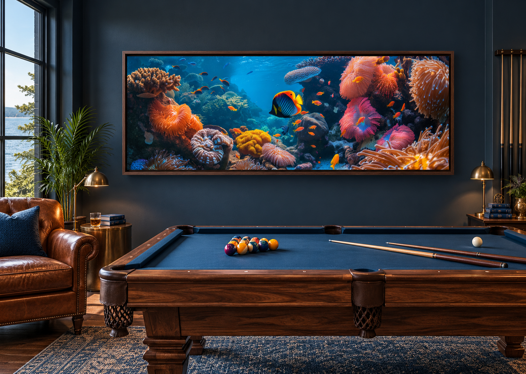 Underwater coral reef narrow horizontal framed canvas wall art above a pool table in a dark room.